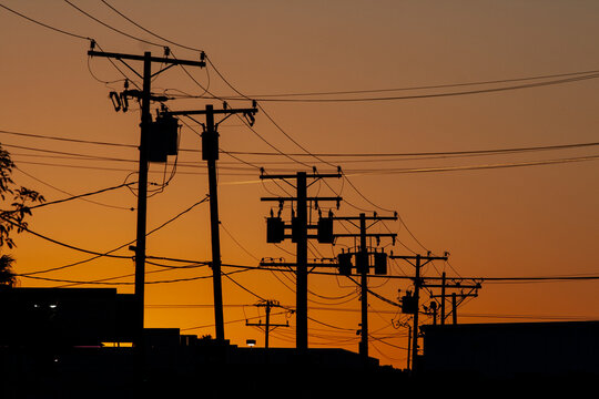 telephone pole, electricity, fire danger, property insurance, silhouette at sunset, wires, lines, energy, industrial, cluttered, chaos, telephone wires, power supply, city, urban, evening, grid, trans
