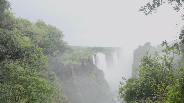 Tourists swimming at Devils pool Victoria Falls waterfalls. Africa world wonder
