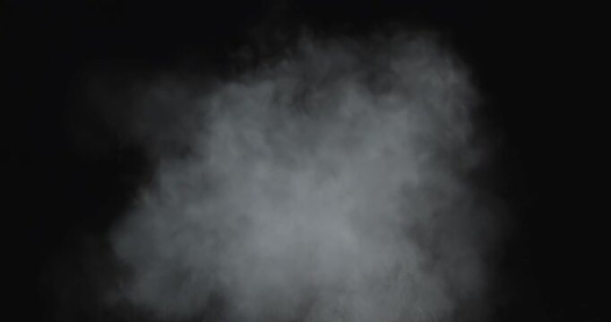 4K VFX practical element slow-motion close-up of dust explosion from bullet hitting the black wall. A dense powder explosion occurs against a black background action element. Gunshot impact on black