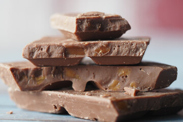 A Mouthwatering Stack of Delicious Chocolate Bars on a Rustic Background