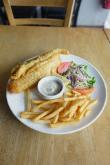 Fish fillet , chips and potato mash on table 