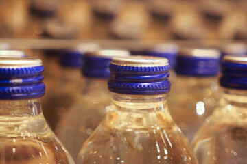 A CloseUp Image Featuring Various Water Bottles with Blue Covers on Top