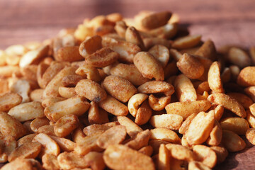 Aesthetic CloseUp Image of Roasted Peanuts Set Against a Bright Orange Background