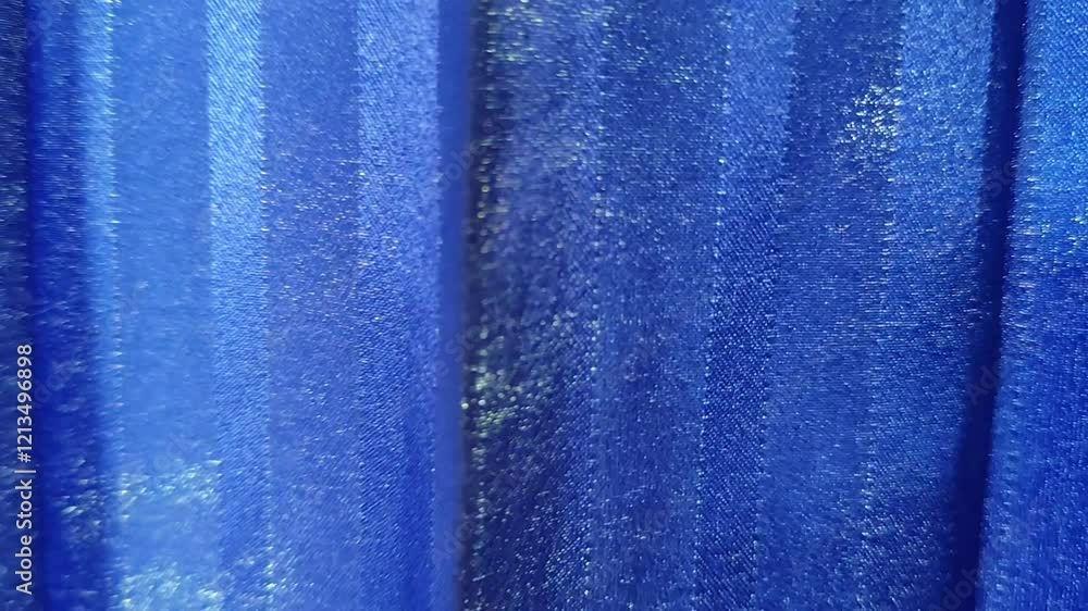 Poster a close-up of blue vertically striped fabric with a slight sheen in a regular pattern