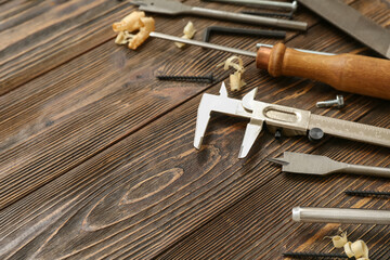 Carpenter's and wood shavings on wooden background
