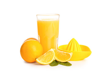 Glass of fresh orange juice with mint and juicer on white background