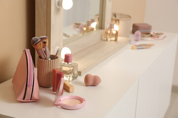 Makeup products on table in room, closeup