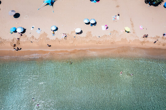 Aerial view of beach with tourists in summer, Paros island, Greece