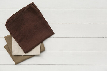 Different napkins on white wooden background