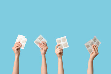 Female hands with mustard plasters on blue background