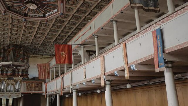 The interior of Codlea's fortified church highlights Gothic vaulted ceilings, wooden pews, and stone walls, reflecting its timeless beauty and historic significance.