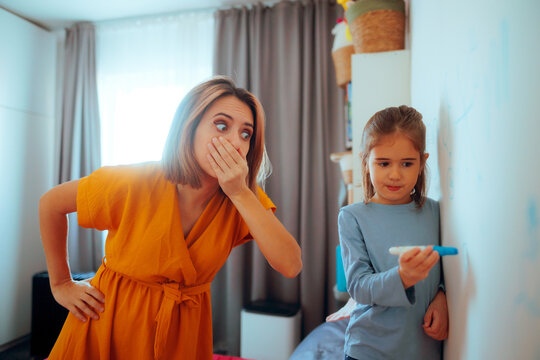 Mother Surprised by her Naughty daughter Writing on Walls. Shocked mom feeling frustrated by disobedient kid 
