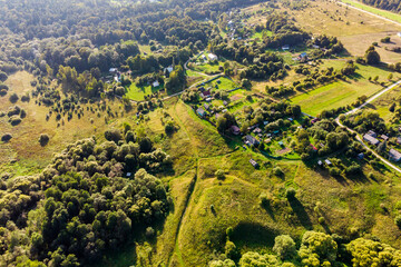 Flight over countryside with village houses, Russia