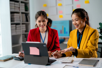 Asian businesswomen working together using laptop in office