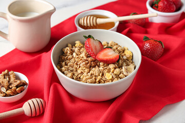 Bowl with delicious granola and berries on marble background