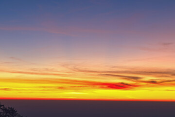 Obraz premium Heaven at early morning with copy space. Sunset, sunrise backdrop.Predawn clear sky with orange horizon and blue atmosphere. Smooth orange blue gradient of dawn sky.