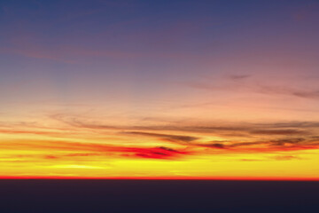 Heaven at early morning with copy space. Sunset, sunrise backdrop.Predawn clear sky with orange horizon and blue atmosphere. Smooth orange blue gradient of dawn sky.