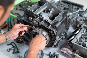 Maintenance of clutch plate replacement by technician, engineer is removing the clutch plate to measure clearance or replace it.