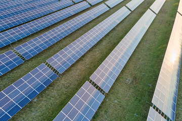 Aerial view of large sustainable electrical power plant with rows of solar photovoltaic panels for producing clean ecological electric energy. Renewable electricity with zero emission concept