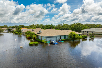 Flooded houses and cars from hurricane Debby rainfall water in Laurel Meadows community in...