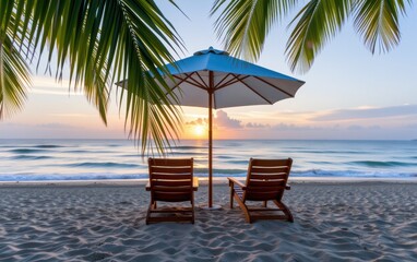 Obraz premium A tranquil beach scene at sunrise with two wooden lounge chairs positioned under a white umbrella.