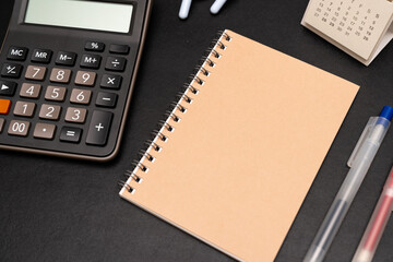 Blank Notebook with calculator and office supplies. Copy space for text. Place for an inscription, business concept.