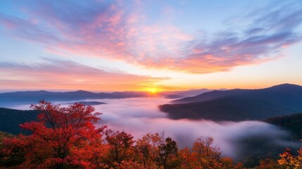 Obraz premium Autumn sunrise over misty mountain valley, vibrant foliage foreground, scenic travel postcard