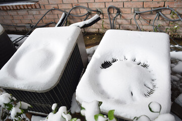 AC outdoor unit or Central Air Conditioner Condenser covered with snow 