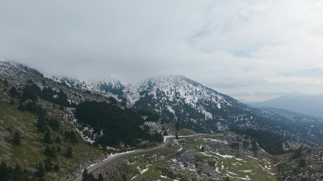 Taking off from Agali Shelter and soaring through the clouds to reveal the peak of Mount Dirfis in Evia