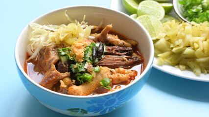 rice vermicelli with northern thai curry sauce on blue background