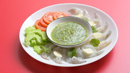 shrimp in fish sauce with Thai spicy seafood dipping sauce on white plate