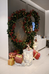 Chrismast decoration details with green leafy plants, gift boxes, owl and reindeer toy