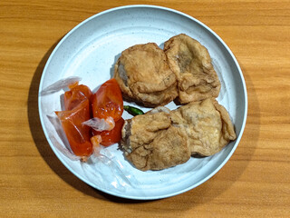 Tahu pentol served with tomato sauce, a traditional Indonesian food.
