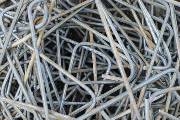 A pile of a lot of slightly rusty cast iron or rebar for a square-shaped building, the photo was taken close up with a high angle