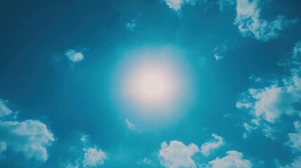 Obraz premium A minimalist photo of a vibrant blue sky, with the sun shining brightly in the center, creating a glowing focal point.