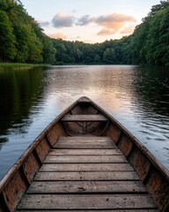 Wooden boat on calm lake at sunset