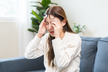 Eye care problem concept, fatigue asian young woman tired eyes irritated rubbing, massage eye dry...