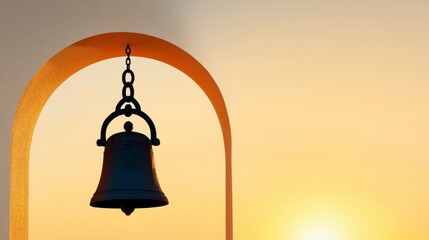 Obraz premium Silhouetted Bell Hanging in Archway at Sunset, Evoking Tranquility and Reflection