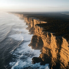 Jagged cliffs stretching along a vast coastline their bases covered in frothy waves and their tops...