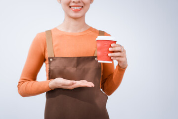 Asian female barista with a beautiful smile, skillfully making coffee in a cozy small shop, creating a warm and welcoming atmosphere for customers in the charming cafe