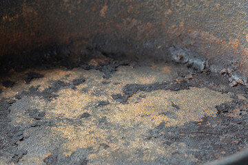 Close up of an old rusty cast iron frying pan background. Vintage cooking utensil concept