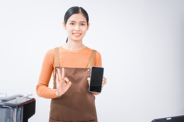 Asian female barista with a beautiful smile, skillfully making coffee in a cozy small shop, creating a warm and welcoming atmosphere for customers in the charming cafe