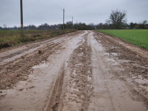 The muddy rural road becomes more challenging to navigate after a significant rainfall