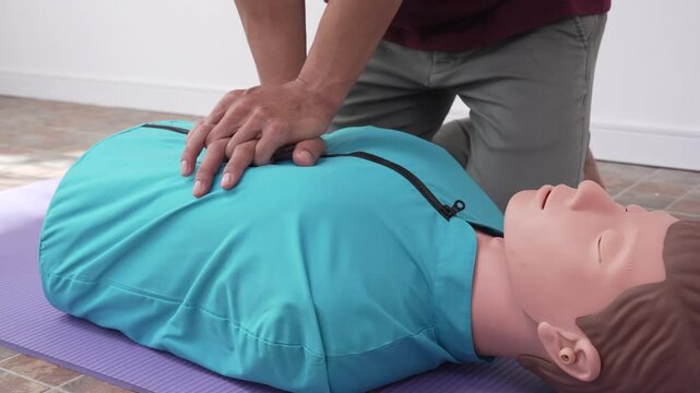A female demonstrates CPR using dummy during life-saving training sessions,equipping participants with essential emergency skills ensure safety, provide critical care,respond effectively emergencies