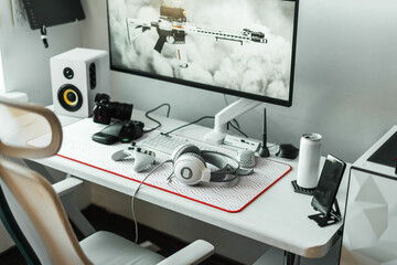 Cozy gaming space featuring modern setup with computer, large monitor, ergonomic chair, organized...