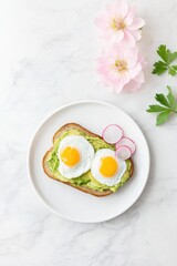 Smashed avocado toast masterpiece with poached eggs and radishes garnished with fresh flowers and herbs