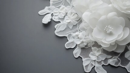 White fabric flowers and lace on gray background