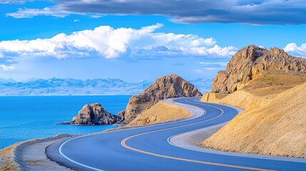 Fototapeta premium Coastal highway curves along scenic lake under blue sky. Travel, tourism