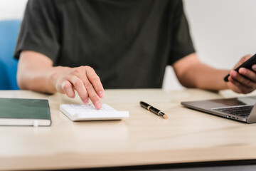 A businessman sitting at a desk in an office, using a laptop, representing accounting, finance,business planning, managing financial data,strategizing business growth,overseeing financial operations