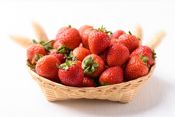 Strawberry fruit in basket on white background